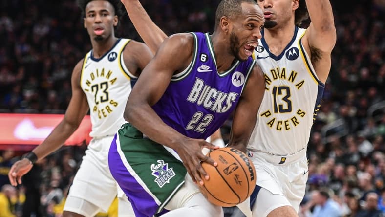 Mar 16, 2023; Milwaukee, Wisconsin, USA; Milwaukee Bucks forward Khris Middleton (22) drives for the basket against Indiana Pacers forward Jordan Nwora (13) in the second quarter at Fiserv Forum. Mandatory Credit: Benny Sieu-USA TODAY Sports