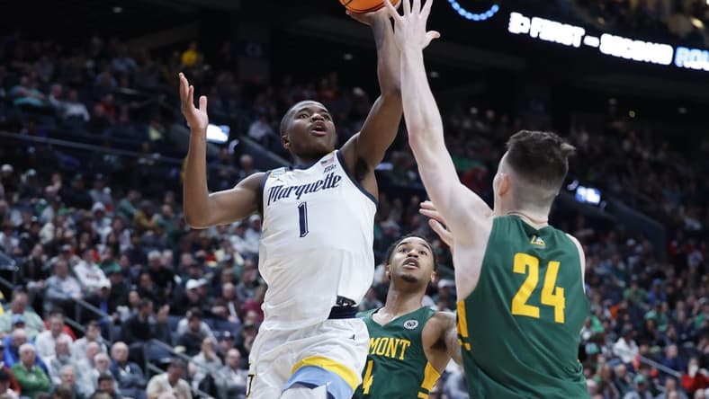 Mar 17, 2023; Columbus, OH, USA; Marquette Golden Eagles guard Kam Jones (1) shoots the ball over Vermont Catamounts forward Matt Veretto (24) in the second half at Nationwide Arena. Mandatory Credit: Rick Osentoski-USA TODAY Sports