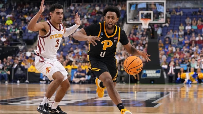 Mar 17, 2023; Greensboro, NC, USA; /p0/ dribbles the ball while defended by Iowa State Cyclones guard Tamin Lipsey (3) during the first half at Greensboro Coliseum. Mandatory Credit: Bob Donnan-USA TODAY Sports