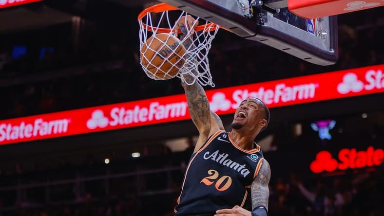 Mar 17, 2023; Atlanta, Georgia, USA; Atlanta Hawks forward John Collins (20) dunks against the Golden State Warriors in the first quarter at State Farm Arena. Mandatory Credit: Brett Davis-USA TODAY Sports