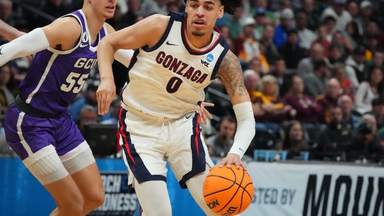 Mar 17, 2023; Denver, CO, USA; Gonzaga Bulldogs guard Julian Strawther (0) drives past Grand Canyon Antelopes guard Walter Ellis (55) during the first half at Ball Arena. Mandatory Credit: Ron Chenoy-USA TODAY Sports