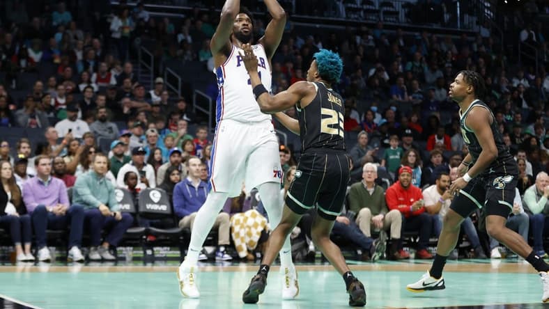 Mar 17, 2023; Charlotte, North Carolina, USA; Philadelphia 76ers center Joel Embiid (21) shoots over Charlotte Hornets forward Kai Jones (23) during the first half at Spectrum Center. Mandatory Credit: Brian Westerholt-USA TODAY Sports