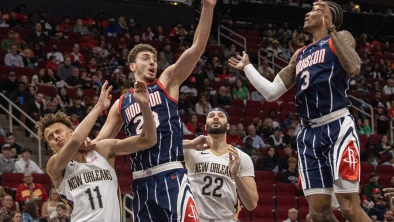 Mar 17, 2023; Houston, Texas, USA; Houston Rockets center Alperen Sengun (28) and guard Kevin Porter Jr. (3) try to grab a rebound against New Orleans Pelicans forward Larry Nance Jr. (22) and guard Dyson Daniels (11) in the first quarter at Toyota Center. Mandatory Credit: Thomas Shea-USA TODAY Sports