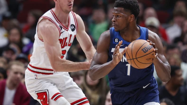 Mar 17, 2023; Chicago, Illinois, USA; Minnesota Timberwolves guard Anthony Edwards (1) is defended by Chicago Bulls guard Alex Caruso (6) during the first half at United Center. Mandatory Credit: Kamil Krzaczynski-USA TODAY Sports
