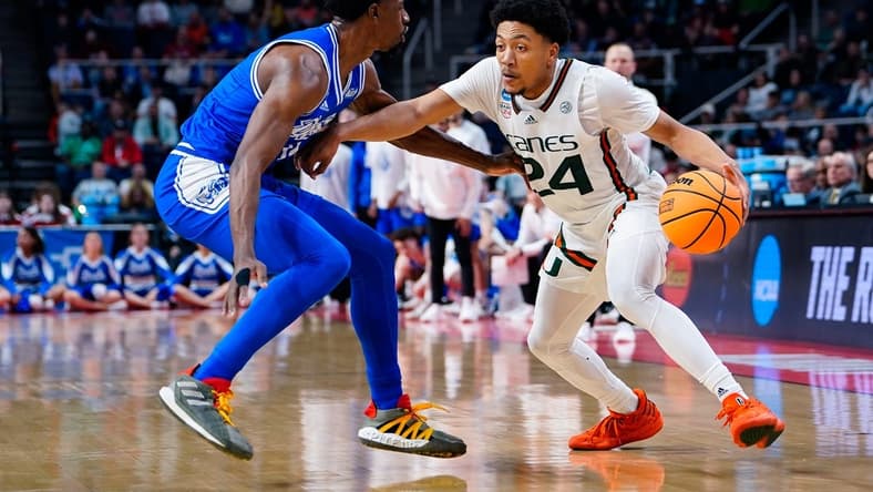 Mar 17, 2023; Albany, NY, USA; Miami Hurricanes guard Nijel Pack (24) controls the ball against Drake Bulldogs guard Sardaar Calhoun (14) in the second half at MVP Arena. Mandatory Credit: Gregory Fisher-USA TODAY Sports