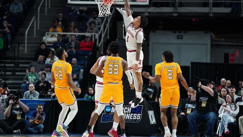 Mar 17, 2023; Albany, NY, USA; Indiana Hoosiers guard Jalen Hood-Schifino (1) dunks the ball as Kent State Golden Flashes center Cli'Ron Hornbeak (42) and forward Malik Reneau (5) and forward Miryne Thomas (33) and guard Malique Jacobs (2) look on in the first half at MVP Arena. Mandatory Credit: David Butler II-USA TODAY Sports