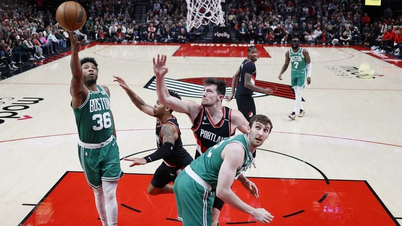 Mar 17, 2023; Portland, Oregon, USA; Boston Celtics point guard Marcus Smart (36) shoots the ball against Portland Trail Blazers shooting guard Anfernee Simons (1, center) and power forward Drew Eubanks (24) uring the first half at Moda Center. Mandatory Credit: Soobum Im-USA TODAY Sports