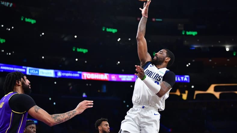 Mar 17, 2023; Los Angeles, California, USA; Dallas Mavericks guard Kyrie Irving (2) shoots against Los Angeles Lakers forward Anthony Davis (3) during the first half at Crypto.com Arena. Mandatory Credit: Gary A. Vasquez-USA TODAY Sports