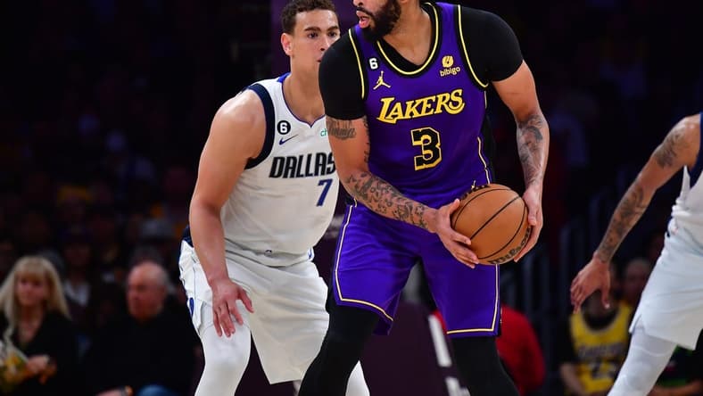 Mar 17, 2023; Los Angeles, California, USA; Los Angeles Lakers forward Anthony Davis (3) controls the ball against Dallas Mavericks center Dwight Powell (7) during the first half at Crypto.com Arena. Mandatory Credit: Gary A. Vasquez-USA TODAY Sports