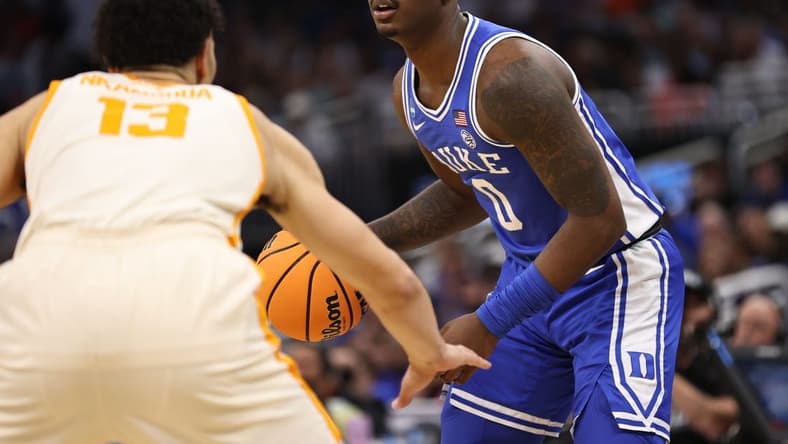 Mar 18, 2023; Orlando, FL, USA; Duke Blue Devils forward Dariq Whitehead (0) is defended by Tennessee Volunteers forward Olivier Nkamhoua (13) during the first half in the second round of the 2023 NCAA Tournament at Legacy Arena. Mandatory Credit: Matt Pendleton-USA TODAY Sports