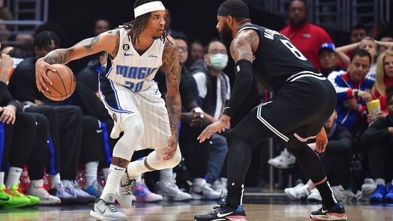 Mar 18, 2023; Los Angeles, California, USA; Orlando Magic guard Markelle Fultz (20) controls the ball against Los Angeles Clippers forward Marcus Morris Sr. (8) during the first half at Crypto.com Arena. Mandatory Credit: Gary A. Vasquez-USA TODAY Sports