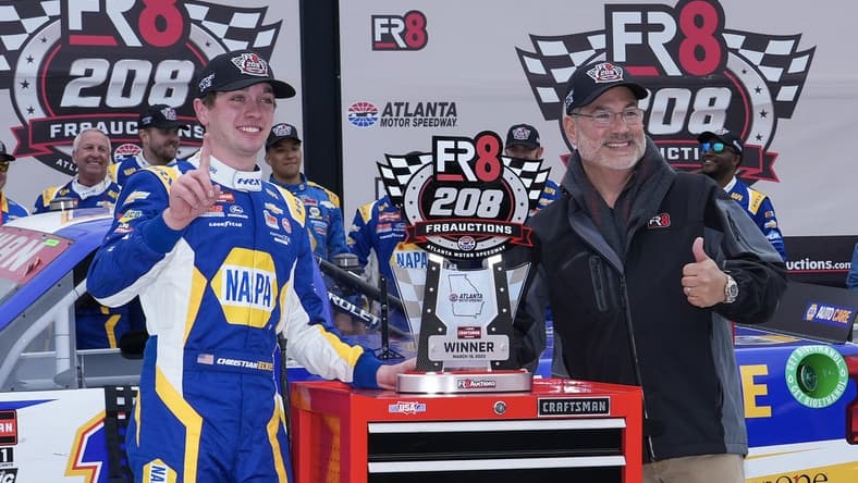 Mar 18, 2023; Hampton, Georgia, USA; NASCAR Craftsman Truck Series driver Christian Eckes (19) (left) celebrates in Victory Lane after winning the FR8 208 at Atlanta Motor Speedway. Mandatory Credit: David Yeazell-USA TODAY Sports