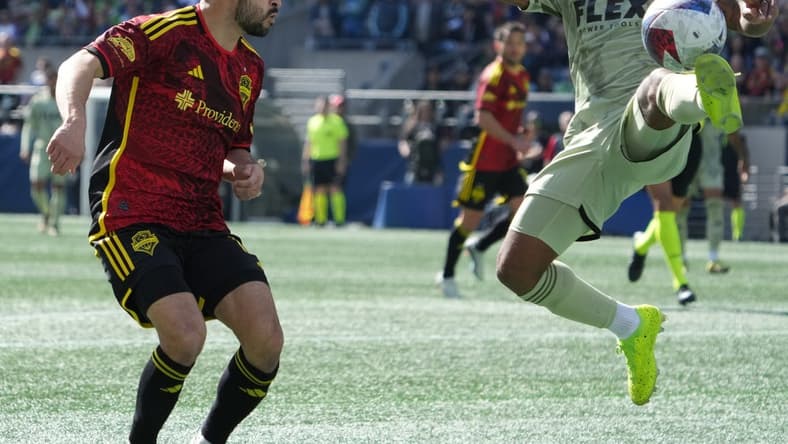 Mar 18, 2023; Seattle, Washington, USA; Seattle Sounders midfielder Alex Roldan (16) and Los Angeles FC defender Diego Palacios (12) battle for the ball during the first half at Lumen Field. Mandatory Credit: Kirby Lee-USA TODAY Sports
