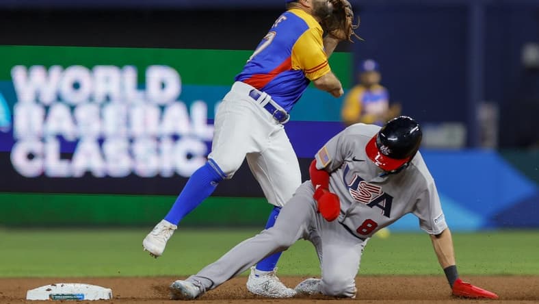 Mar 18, 2023; Miami, Florida, USA; Venezuela second baseman Jose Altuve (27) turns a double play over USA shortstop Trea Turner (8) during the second inning at LoanDepot Park. Mandatory Credit: Sam Navarro-USA TODAY Sports