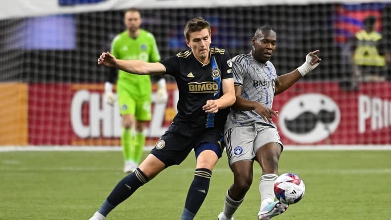Mar 18, 2023; Montreal, Quebec, CAN; Philadelphia Union defender Jakob Glesnes (5) defends the ball against CF Montreal defender Kamal Miller (3) during first half at Olympic Stadium. Mandatory Credit: David Kirouac-USA TODAY Sports