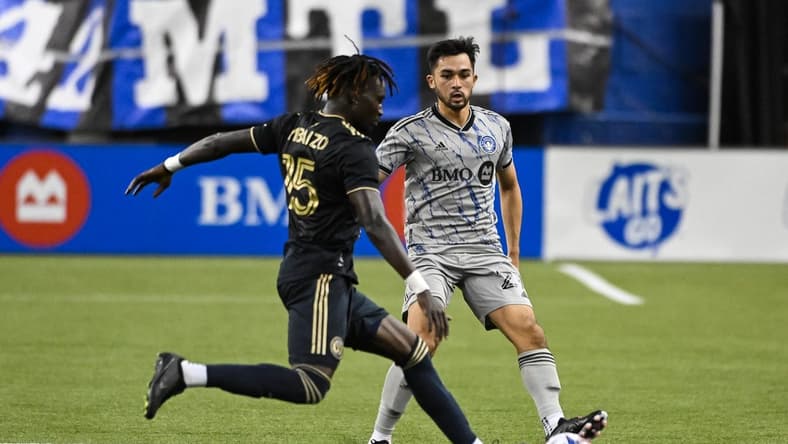 Mar 18, 2023; Montreal, Quebec, CAN; Philadelphia Union defender Olivier Mbaizo (15) defends the ball against CF Montreal midfielder Mathieu Choiniere (29) during first half at Olympic Stadium. Mandatory Credit: David Kirouac-USA TODAY Sports