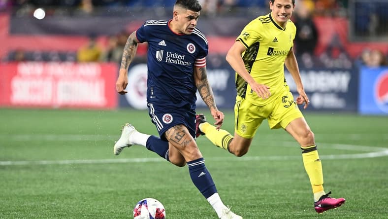 Mar 18, 2023; Foxborough, Massachusetts, USA; New England Revolution forward Gustavo Bou (7) controls the ball in front of Nashville SC midfielder Sean Davis (54) during the second half at Gillette Stadium. Mandatory Credit: Brian Fluharty-USA TODAY Sports