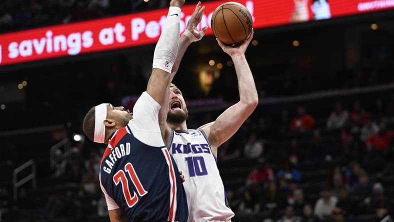 Mar 18, 2023; Washington, District of Columbia, USA; Sacramento Kings forward Domantas Sabonis (10) shoots over Washington Wizards center Daniel Gafford (21) during the first half at Capital One Arena. Mandatory Credit: Brad Mills-USA TODAY Sports