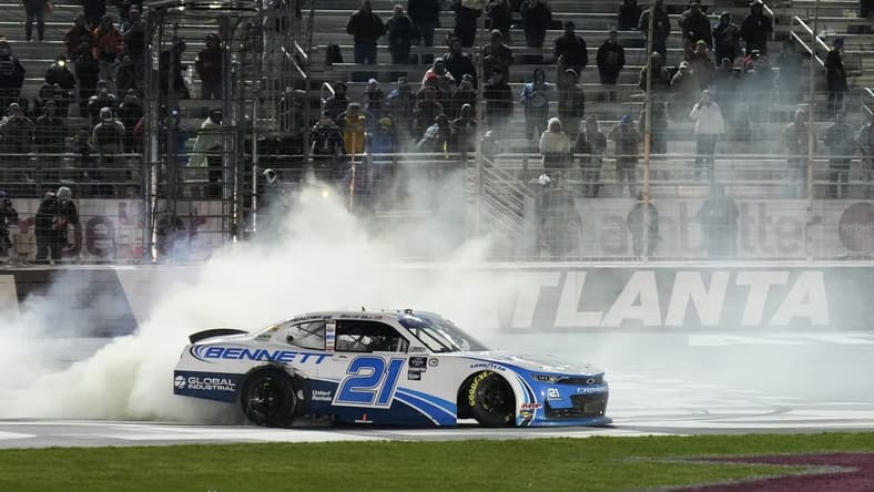 Mar 18, 2023; Hampton, Georgia, USA; NASCAR Xfinity Series driver Austin Hill (21) does a celebratory burn at Atlanta Motor Speedway. Mandatory Credit: David Yeazell-USA TODAY Sports