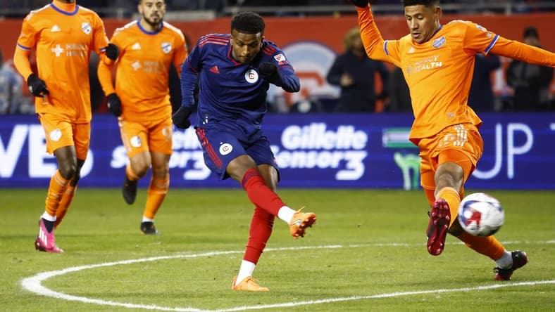 Mar 18, 2023; Chicago, Illinois, USA; Chicago Fire midfielder Maren Haile-Selassie (7) shoots the ball against FC Cincinnati forward Brenner (9) during the first half at Soldier Field. Mandatory Credit: Mike Dinovo-USA TODAY Sports