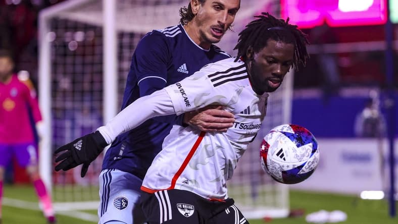 Mar 18, 2023; Frisco, Texas, USA;  Sporting Kansas City defender Ben Sweat (2) and FC Dallas midfielder Ema Twumasi (22) go for the ball during the first half at Toyota Stadium. Mandatory Credit: Kevin Jairaj-USA TODAY Sports