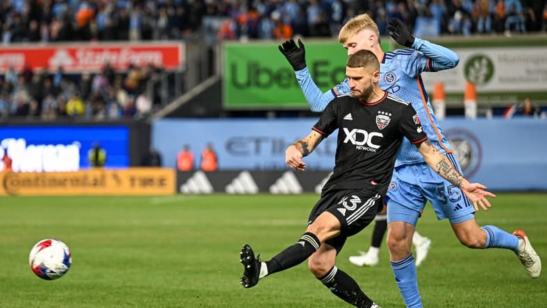 Mar 18, 2023; New York, New York, USA; D.C. United midfielder Mateusz Klich (43) crosses the ball defended by New York City FC midfielder Keaton Parks (55) during the second half at Yankee Stadium. Mandatory Credit: Mark Smith-USA TODAY Sports