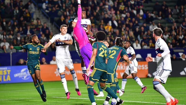 Mar 18, 2023; Carson, California, USA; Los Angeles Galaxy goalkeeper Jonathan Bond (1) blocks a shot against the Vancouver Whitecaps during the first half at Dignity Health Sports Park. Mandatory Credit: Gary A. Vasquez-USA TODAY Sports
