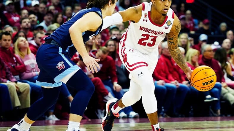 Wisconsin guard Chucky Hepburn (23) drives to the basket as Liberty guard Colin Porter (0) attempts to block him during the second half of their game of the second round of the National Invitation Tournament on Sunday March 19, 2023 at the Kohl Center in Madison, Wis.