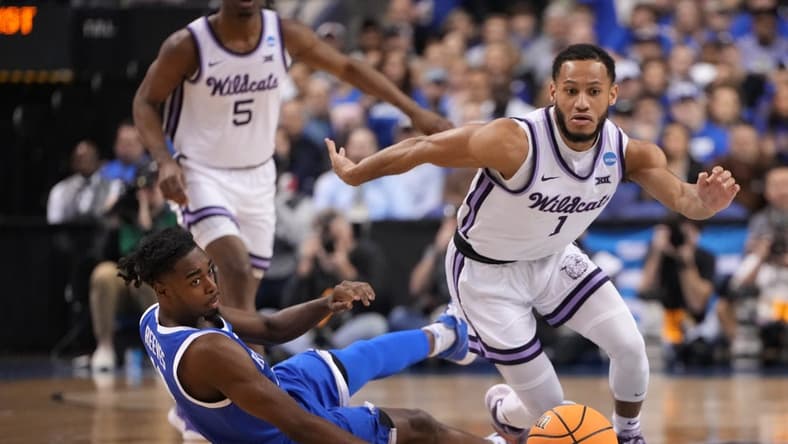 Mar 19, 2023; Greensboro, NC, USA; Kansas State Wildcats guard Markquis Nowell (1) and Kentucky Wildcats guard Antonio Reeves (12) both go for a loose ball during the first half in the second round of the 2023 NCAA men s basketball tournament at Greensboro Coliseum. Mandatory Credit: Bob Donnan-USA TODAY Sports