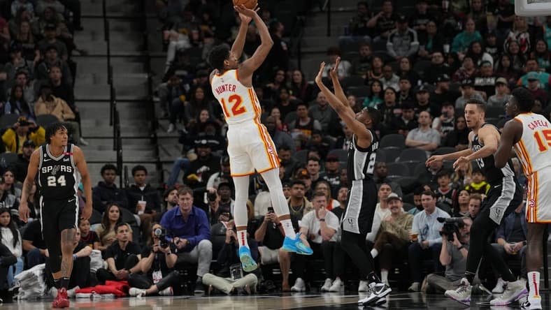 Mar 19, 2023; San Antonio, Texas, USA; Atlanta Hawks forward De'Andre Hunter (12) shoots over San Antonio Spurs guard Malaki Branham (22) in the first half at the AT&T Center. Mandatory Credit: Daniel Dunn-USA TODAY Sports