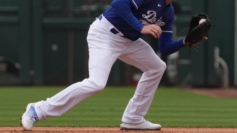 Mar 19, 2023; Phoenix, Arizona, USA; Los Angeles Dodgers first baseman Freddie Freeman (5) fields a ground ball against the Oakland Athletics during the third inning at Camelback Ranch-Glendale. Mandatory Credit: Joe Camporeale-USA TODAY Sports