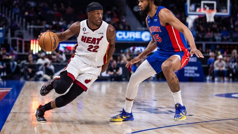 Mar 19, 2023; Detroit, Michigan, USA; Miami Heat forward Jimmy Butler (22) drives to the basket against Detroit Pistons forward Marvin Bagley III (35) in the first quarter at Little Caesars Arena. Mandatory Credit: Allison Farrand-USA TODAY Sports