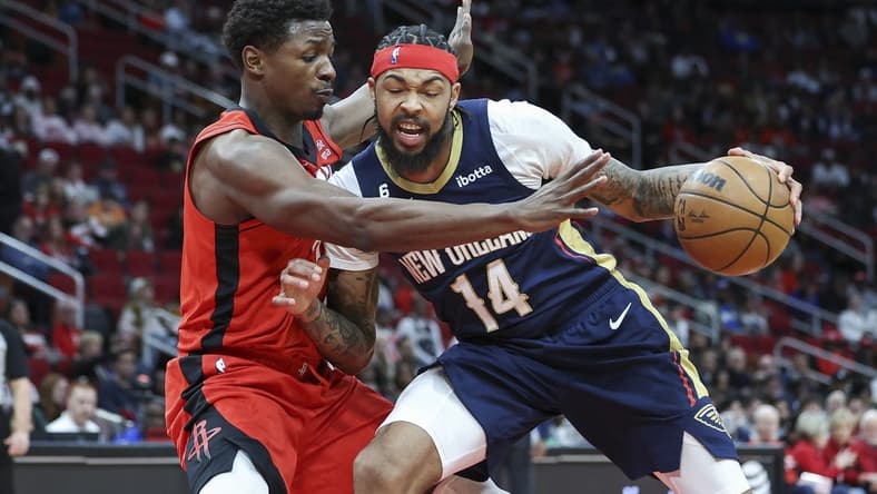 Mar 19, 2023; Houston, Texas, USA; New Orleans Pelicans forward Brandon Ingram (14) controls the ball as Houston Rockets forward Jae'Sean Tate (8) defends during the second quarter at Toyota Center. Mandatory Credit: Troy Taormina-USA TODAY Sports
