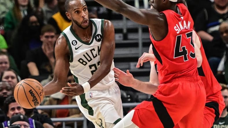 Mar 19, 2023; Milwaukee, Wisconsin, USA; Milwaukee Bucks forward Khris Middleton (22) looks to pass against Toronto Raptors forward Pascal Siakam (43) in the fourth quarter at Fiserv Forum. Mandatory Credit: Benny Sieu-USA TODAY Sports