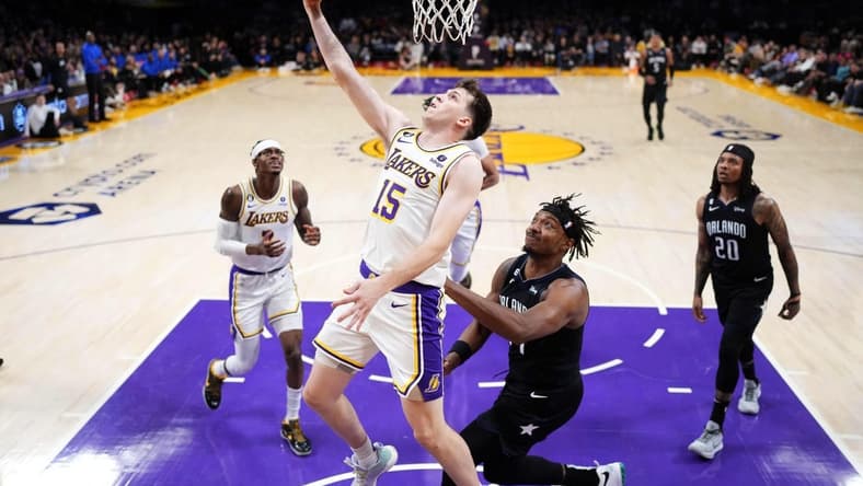 Mar 19, 2023; Los Angeles, California, USA; Los Angeles Lakers guard Austin Reaves (15) shoots against the Orlando Magic in the first half at Crypto.com Arena. Mandatory Credit: Kirby Lee-USA TODAY Sports