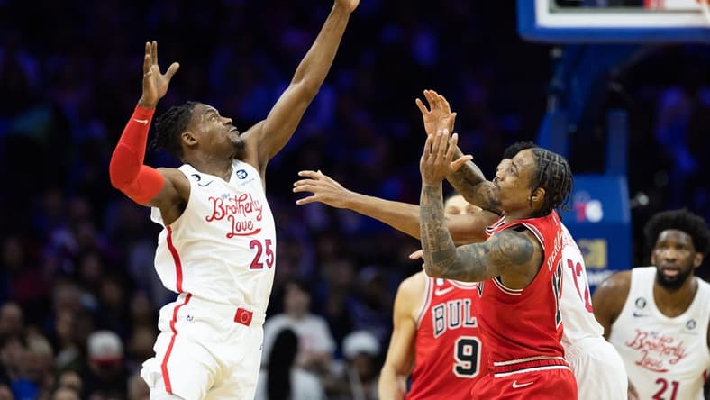 Mar 20, 2023; Philadelphia, Pennsylvania, USA; Philadelphia 76ers forward Danuel House Jr. (25) tips the ball past Chicago Bulls forward DeMar DeRozan (11) during the second quarter at Wells Fargo Center. Mandatory Credit: Bill Streicher-USA TODAY Sports