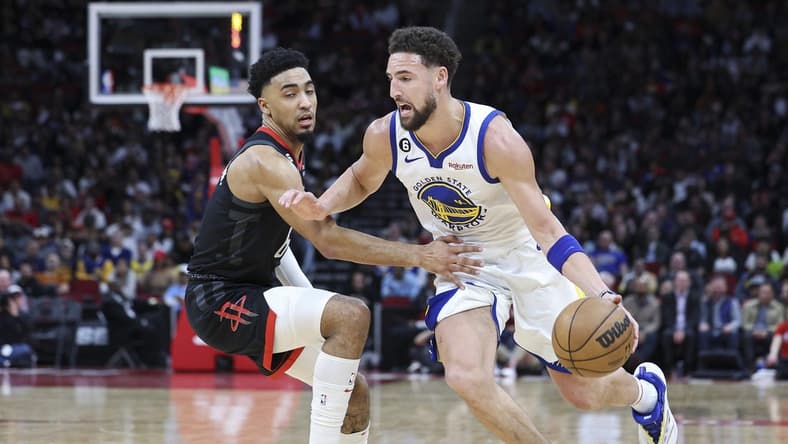 Mar 20, 2023; Houston, Texas, USA; Golden State Warriors guard Klay Thompson (11) drives with the ball as Houston Rockets forward KJ Martin (6) defends during the second quarter at Toyota Center. Mandatory Credit: Troy Taormina-USA TODAY Sports