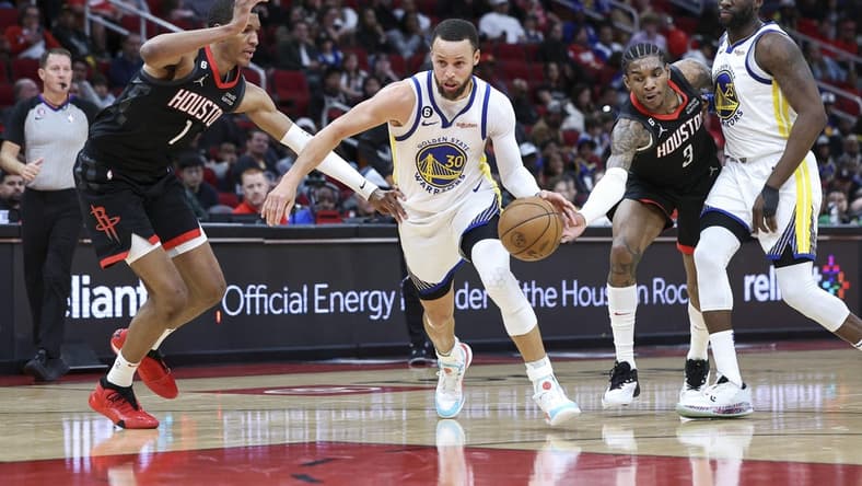 Mar 20, 2023; Houston, Texas, USA; Golden State Warriors guard Stephen Curry (30) drives with the ball as Houston Rockets forward Jabari Smith Jr. (1) and guard Kevin Porter Jr. (3) defend during the second quarter at Toyota Center. Mandatory Credit: Troy Taormina-USA TODAY Sports