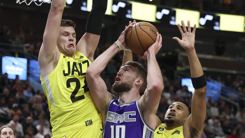 Mar 20, 2023; Salt Lake City, Utah, USA; Sacramento Kings forward Domantas Sabonis (10) goes to the basket between Utah Jazz center Walker Kessler (24) and guard Talen Horton-Tucker (0) in the first quarter at Vivint Arena. Mandatory Credit: Rob Gray-USA TODAY Sports