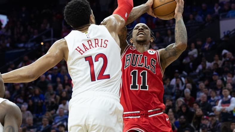 Mar 20, 2023; Philadelphia, Pennsylvania, USA; Chicago Bulls forward DeMar DeRozan (11) drives for a shot against Philadelphia 76ers forward Tobias Harris (12) during overtime at Wells Fargo Center. Mandatory Credit: Bill Streicher-USA TODAY Sports