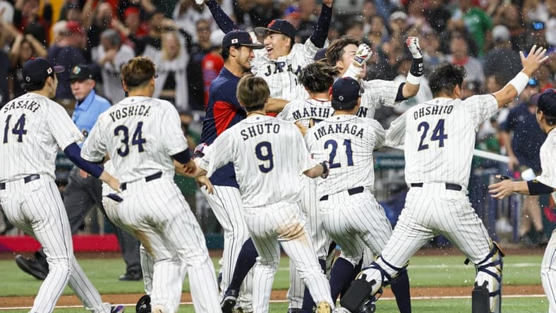 Mar 20, 2023; Miami, Florida, USA; Team Japan celebrates on the field after winning the game with a walk-off double from Japan third baseman Munetaka Murakami (55) during the ninth inning against Mexico at LoanDepot Park. Mandatory Credit: Sam Navarro-USA TODAY Sports