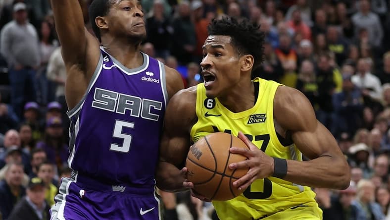 Mar 20, 2023; Salt Lake City, Utah, USA; Utah Jazz guard Ochai Agbaji (30) drives against Sacramento Kings guard De'Aaron Fox (5) in the fourth quarter at Vivint Arena. Mandatory Credit: Rob Gray-USA TODAY Sports