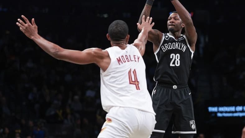 Mar 21, 2023; Brooklyn, New York, USA; Brooklyn Nets forward Dorian Finney-Smith (28) shoots the ball against Cleveland Cavaliers forward Evan Mobley (4) during the second half at Barclays Center. Mandatory Credit: Vincent Carchietta-USA TODAY Sports