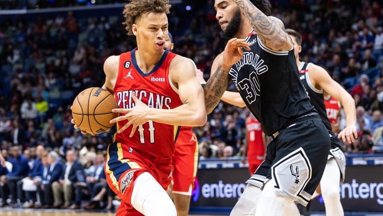 Mar 21, 2023; New Orleans, Louisiana, USA; New Orleans Pelicans guard Dyson Daniels (11) dribbles against San Antonio Spurs forward Julian Champagnie (30)  during the second half at Smoothie King Center. Mandatory Credit: Stephen Lew-USA TODAY Sports