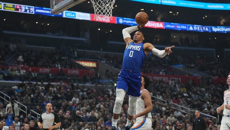Mar 21, 2023; Los Angeles, California, USA; LA Clippers guard Russell Westbrook (0) dunks the ball against the Oklahoma City Thunder in the first half at Crypto.com Arena. Mandatory Credit: Kirby Lee-USA TODAY Sports