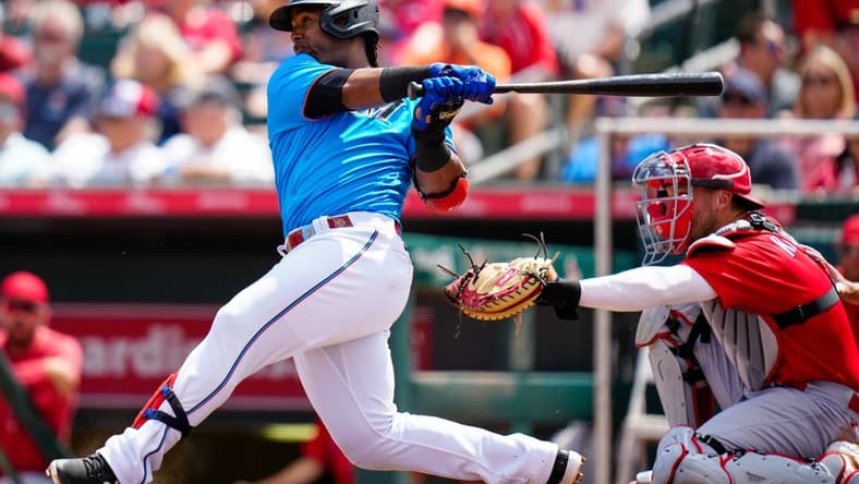 Mar 22, 2023; Jupiter, Florida, USA; Miami Marlins second baseman Jean Segura (9) hits a single against the St. Louis Cardinals during the fourth inning at Roger Dean Stadium. Mandatory Credit: Rich Storry-USA TODAY Sports