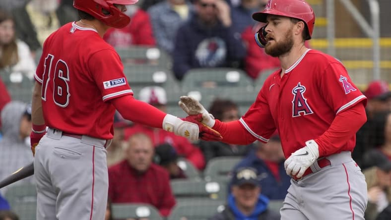Mar 22, 2023; Salt River Pima-Maricopa, Arizona, USA; Los Angeles Angels first baseman Jared Walsh (20) celebrates after hitting a solo home run against the Colorado Rockies with center fielder Mickey Moniak (16) in the second inning at Salt River Fields at Talking Stick. Mandatory Credit: Rick Scuteri-USA TODAY Sports