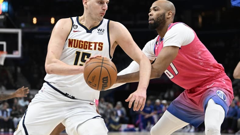 Mar 22, 2023; Washington, District of Columbia, USA; Denver Nuggets center Nikola Jokic (15) dribbles as Washington Wizards forward Taj Gibson (67) defends during the first half at Capital One Arena. Mandatory Credit: Brad Mills-USA TODAY Sports