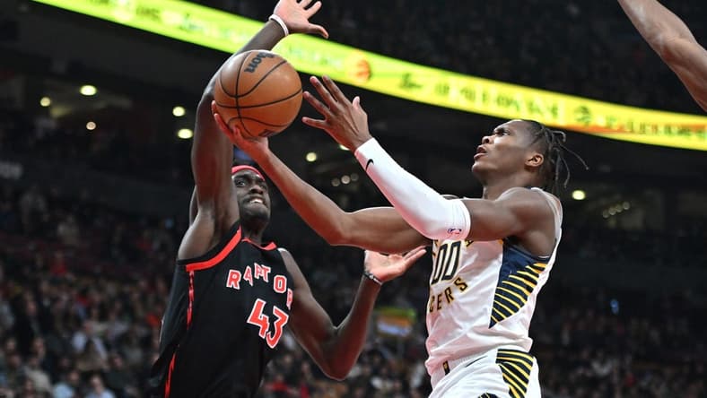 Mar 22, 2023; Toronto, Ontario, CAN;  Indiana Pacers forward Bennedict Mathurin (00) shoots the ball as Toronto Raptors forward Pascal Siakam (43) defends in the first half at Scotiabank Arena. Mandatory Credit: Dan Hamilton-USA TODAY Sports