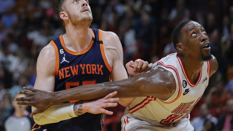 Mar 22, 2023; Miami, Florida, USA; New York Knicks center Isaiah Hartenstein (55) and Miami Heat center Bam Adebayo (13) defend during a free-throw attempt in the second quarter at Miami-Dade Arena. Mandatory Credit: Sam Navarro-USA TODAY Sports